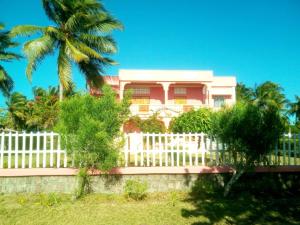 VohemarLignitry的棕榈树屋前的白色围栏