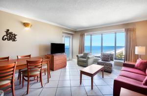 a living room with a dining table and a living room with a view at Palace Resort in Myrtle Beach