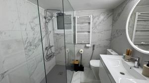 a bathroom with a shower and a toilet and a sink at Luxury 2 Bedroom Apartment in Central Larnaca in Faneromeni Area in Larnaka +7 photos