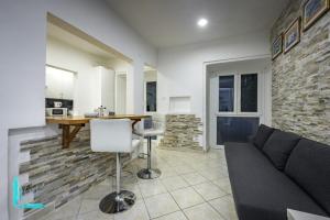 a living room with a couch and a table at Chiabrera11 Aquarium - Genovainrelax in Genova