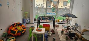 a childs room with a play room with toys and an umbrella at Библиотеката in Pomorie
