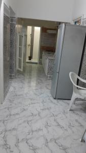 Una habitación vacía con un refrigerador y una silla. en DAR Mahdia, en Túnez 8 fotos más