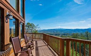 a balcony with chairs and a view of the mountains at Splash Mountain Magic in Dupont Springs