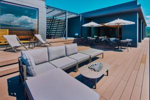 a patio with tables and chairs and umbrellas at edit x seven FUJI GOTEMBA in Gotemba