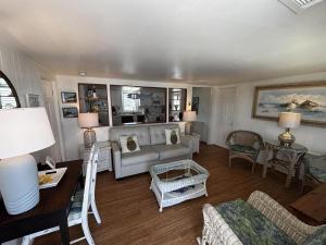 a living room with a couch and a table at Pet Friendly Wifi Beach Badges Beach Chairs Balcony Bayview Deckkeurig Handicap Access Elevator Os Streaming Tv in Brant Beach
