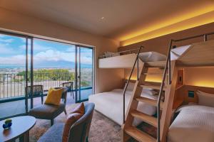 a room with bunk beds and a view of a mountain at edit x seven FUJI GOTEMBA in Gotemba