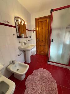 a bathroom with a sink and a toilet and a shower at La casa nel verde in Rapallo