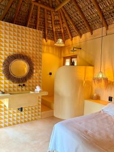 a room with a bed and a mirror on the wall at Casa Moka in Puerto Escondido