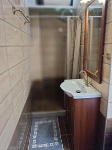 a bathroom with a sink and a mirror at Archanes grandma's house in Archanes +43 photos