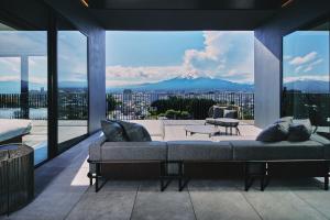 a living room with a couch and a view of a mountain at edit x seven FUJI GOTEMBA in Gotemba