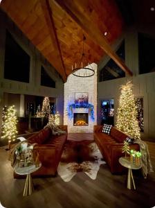 a living room with couches and a fireplace with christmas trees at The Ember in Rocky Grove
