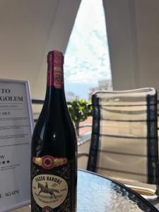 a bottle of wine sitting on top of a table at Roses Place Golem in Golem +12 photos