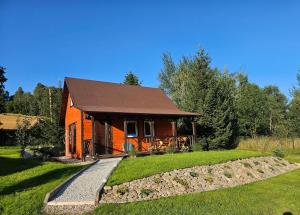 a small cabin with a stone path leading to it at Domek Izerskie Gaje in Wojcieszyce