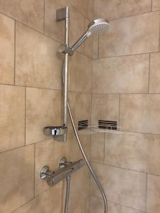 a shower with a shower head in a bathroom at Le Colbert in Nevers +30 photos