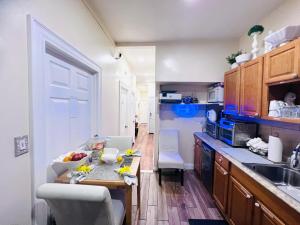 a kitchen with a table with fruit on it at Imperial Stay BNB in Brooklyn