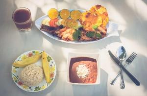 two plates of food sitting on a table with food at Chachamar - Nuqui in Panguí