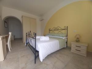 a bedroom with a bed and a table in a room at Il Canto del Mare Rooms & Suites in Porto SantʼElpidio