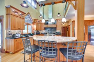 a kitchen with a large island with bar stools at Hot Tub, Gym, Game Room! Luxe Estate in Longmeadow in Longmeadow