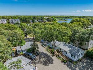 an overhead view of a house with a driveway and trees at 28 Seconsett Point Road Mashpee - Betty's By The Bay in Mashpee