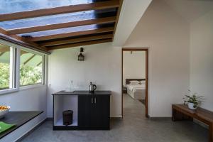 a bathroom with a sink and a bedroom with a bed at Mystic Trees By Cluster Cloud in Thekkady