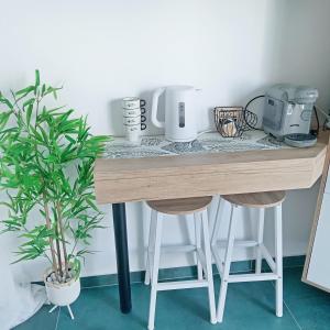 a wooden table with two stools in a room at Sunshine Bungalow in Schitul
