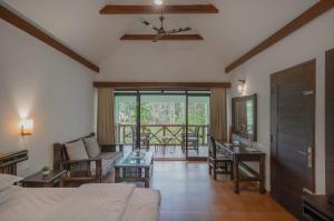 a living room with a bed and a table at Mystic Trees By Cluster Cloud in Thekkady