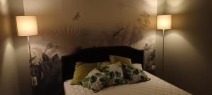 a bedroom with a bed with two lamps on it at MAISON VATOSOA in Talata-maty