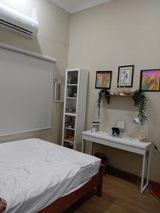a bedroom with a bed and a desk in it at Politeknik metro kl in Kuala Lumpur