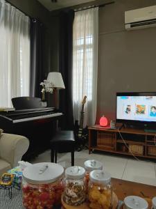 a living room with a piano and jars of food at Politeknik metro kl in Kuala Lumpur