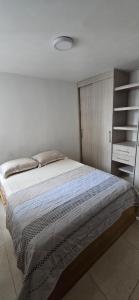 a bedroom with a large bed in a room at Apartamento Plazuela Portal Del Prado in Barranquilla