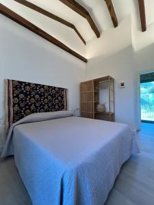 a bedroom with a large bed and a window at A CASIÑA dos LARANXOS in Cenlle +45 photos