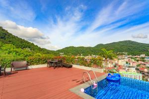 a swimming pool on a deck with a view of a city at Apartments at The Bliss Condo by Lofty in Patong Beach
