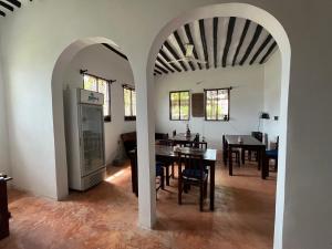a kitchen and dining room with a table and chairs at Naira House in Jambiani +42 photos