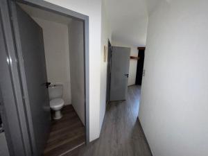 an empty bathroom with a toilet and a hallway at Hôtel Dupleix - Hyper centre - Réouverture in Quimper +27 photos