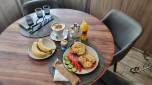 a table with a plate of food and fruit on it at Jeweller Hotel in Ruse