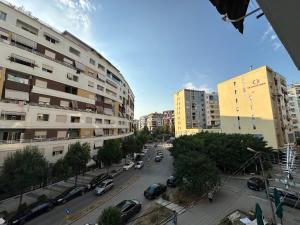 a city street with parked cars and buildings at Starli Apartment - Tirana in Tirana