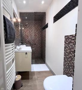 a bathroom with a shower and a toilet and a sink at Secret Brick Garden Deauville in Deauville +20 photos