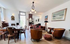 a dining room with a table and chairs at Secret Brick Garden Deauville in Deauville