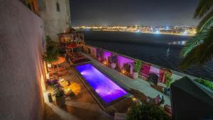 an overhead view of a swimming pool at night at Riad Dar Baraka Rabat in Rabat