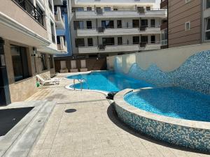 two swimming pools in front of a building at Sunrise Apartment in Pomorie