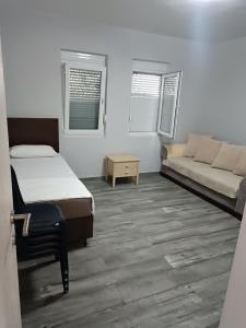 a room with a bed and a couch in it at Infinite Sunset in Ulcinj