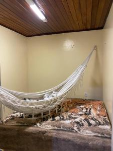 a hammock hanging on a wall in a room at Apartamento no Murubira in Chapéu Virado +13 photos