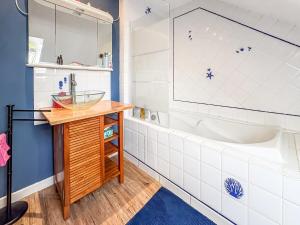 a bathroom with a tub and a sink at La Maison du Lac in La Ferté-Macé +18 photos