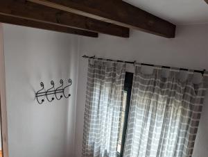 a room with a window with a shower curtain at Casa Corredera in Cumbres Mayores +16 photos