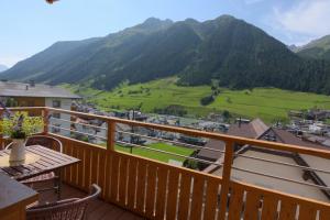 a balcony with a view of a mountain at Apart Günther in Ischgl
