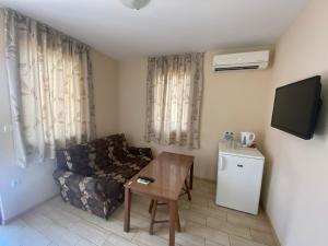 a living room with a couch and a table at Gloria Houses-Free Parking in Varna City