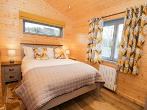 Ένα ή περισσότερα κρεβάτια σε δωμάτιο στο Oak Lodge