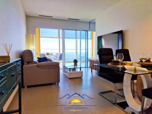 a living room with a couch and a table and chairs at Intempo Golden Magic Sky Resort & Spa in Benidorm