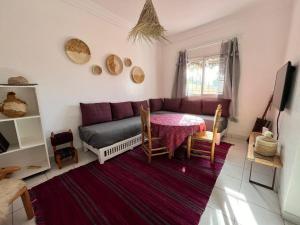 a living room with a couch and a table at Maison avec jardin 3 Chambres a 5min de Essaouira in Ghazoua
