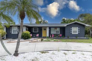 a blue house with a yellow door and a palm tree at Pet Friendly Near Anna Maria And Img in Bradenton
